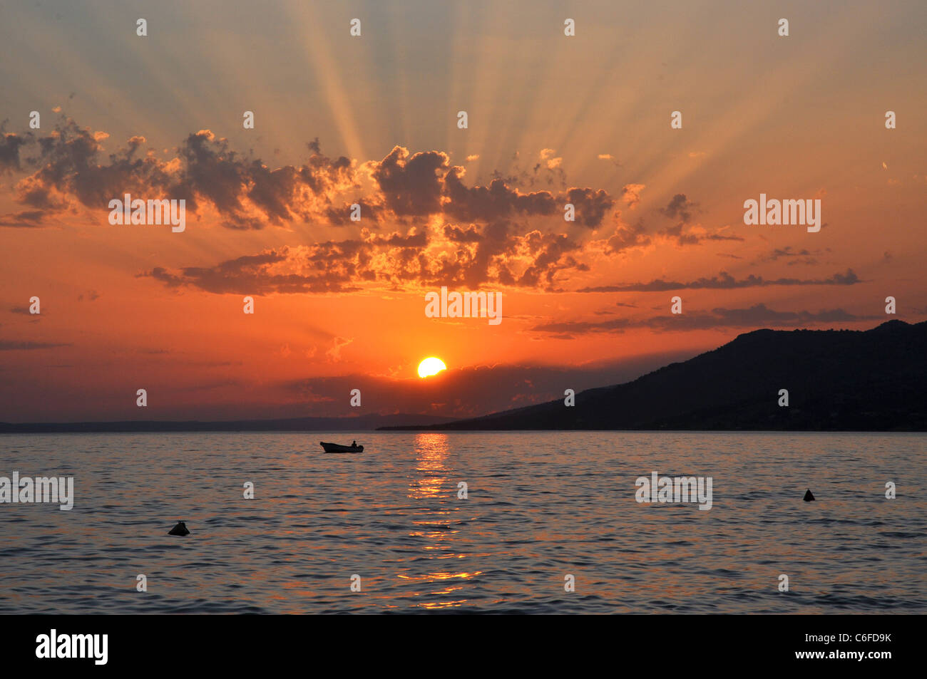 Beautiful Sunset With Sunrays Through Clouds Stock Photo Alamy