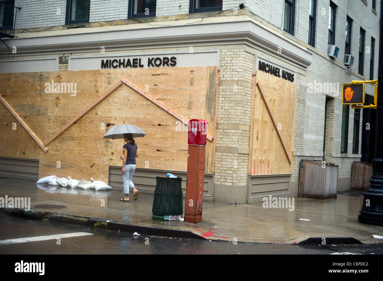 The Michael Kors store sandbags the doors and covers the windows with plywood as protection against Hurricane Irene Stock Photo