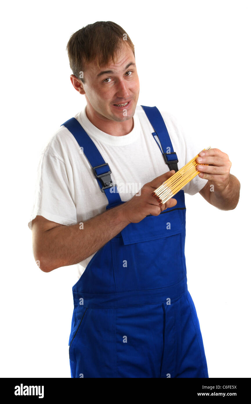 young craftsmen in work clothes holding a ruler Stock Photo