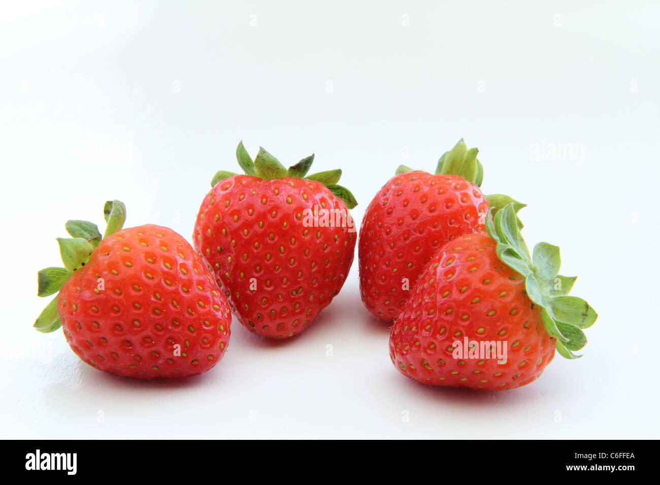 four juicy organic strawberries full of vitamins Stock Photo - Alamy