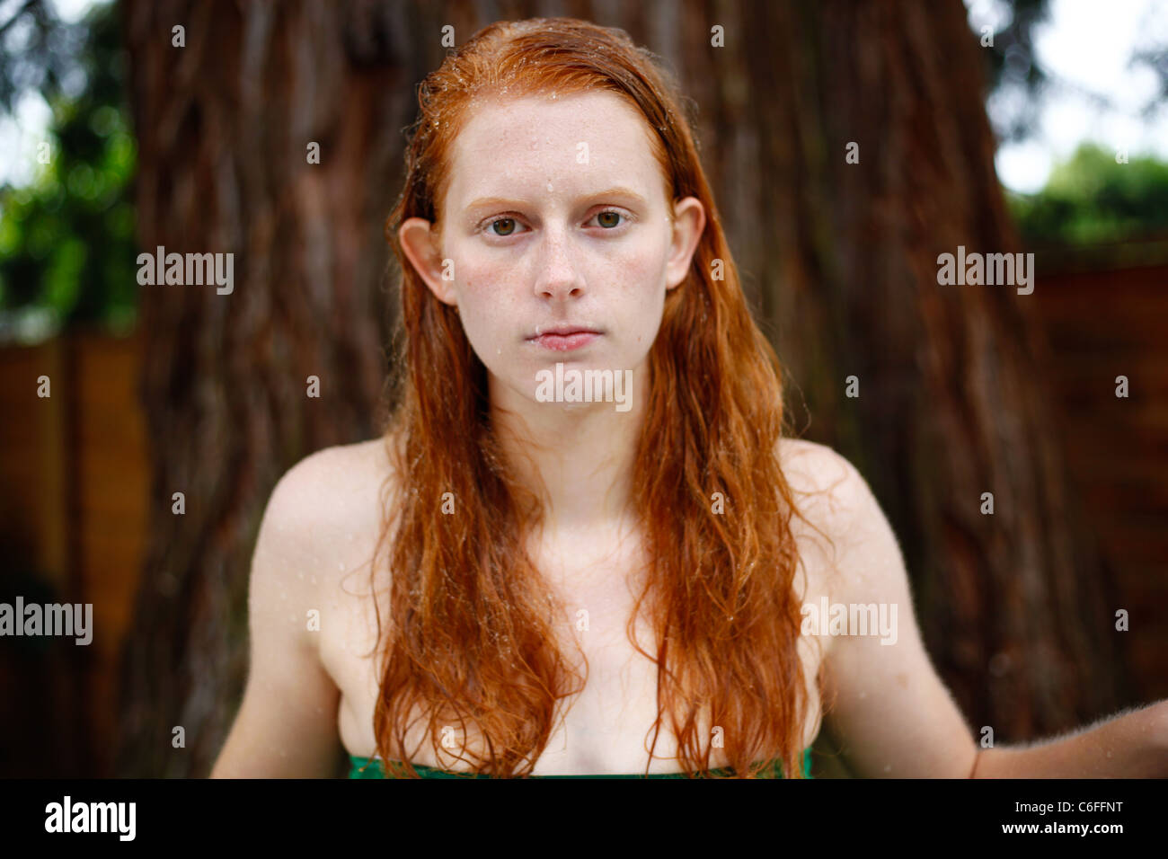 Serious readhead young woman teen with red hair and freckles. Stock Photo