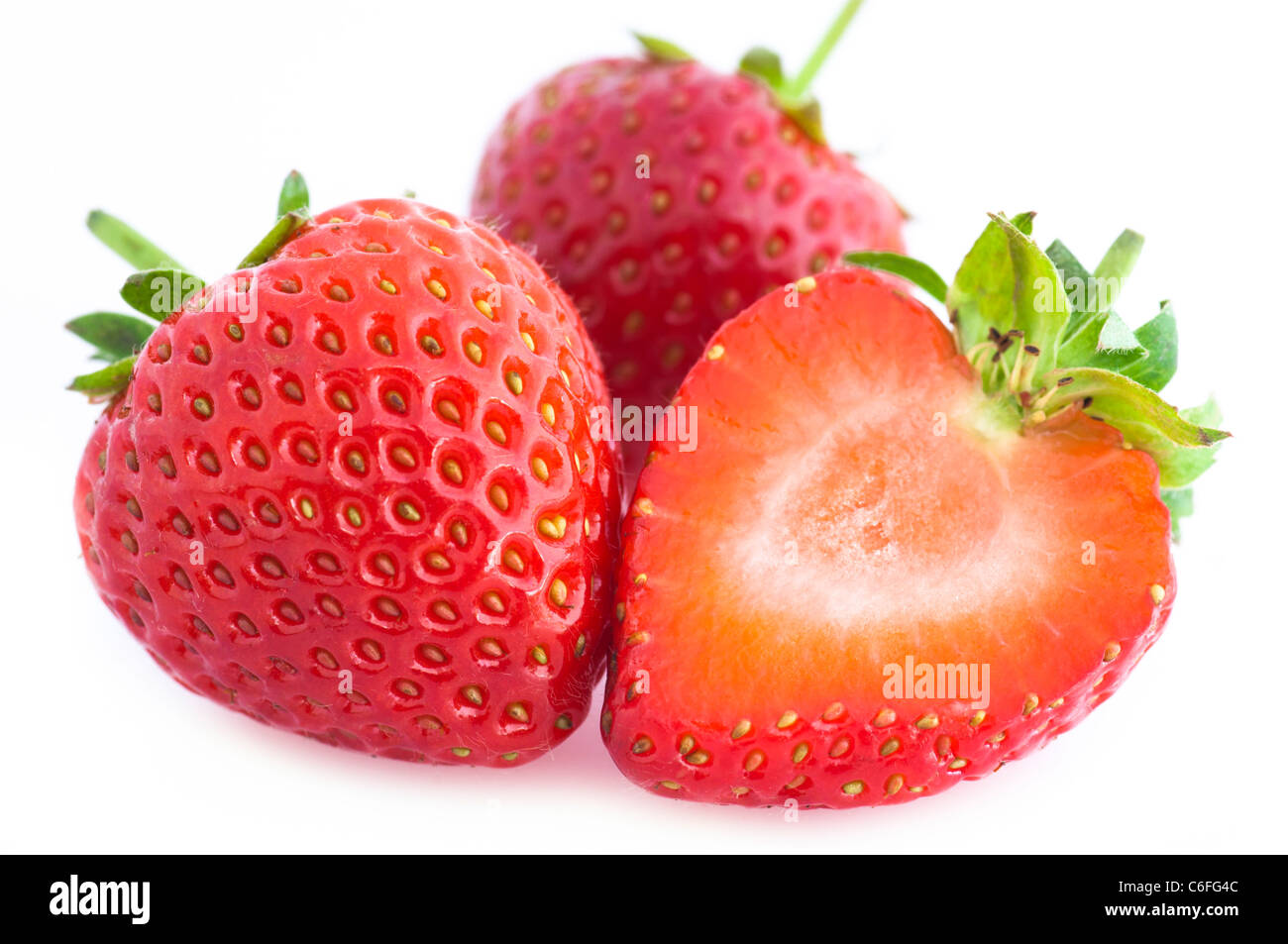 Close Up of Three Strawberries on a White Background. Stock Photo