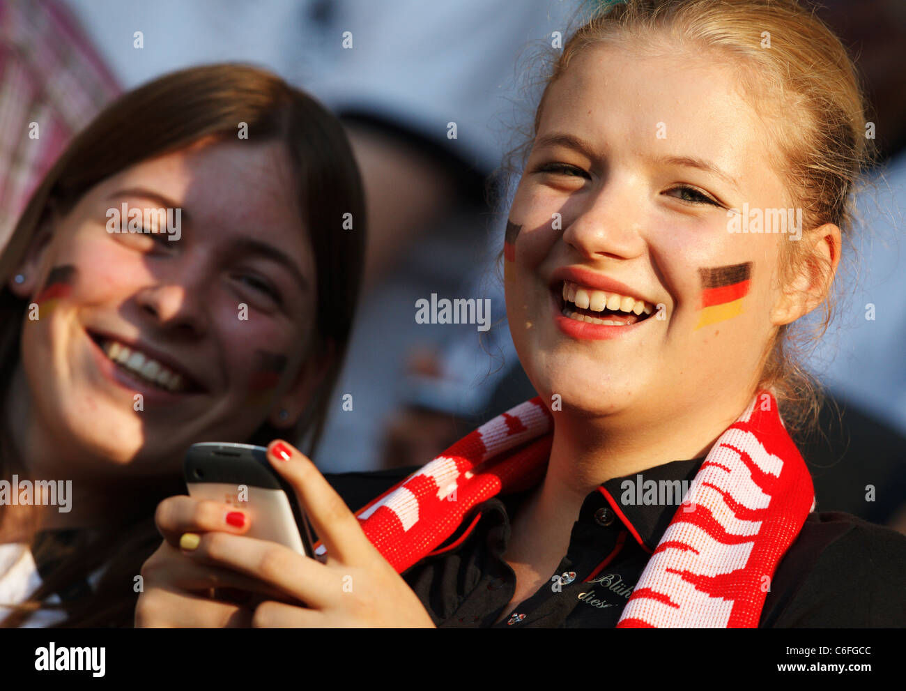 Young Germany supporters smile at a 2011 Women's World Cup quarterfinal soccer match between Germany and Japan July 9, 2011. Stock Photo
