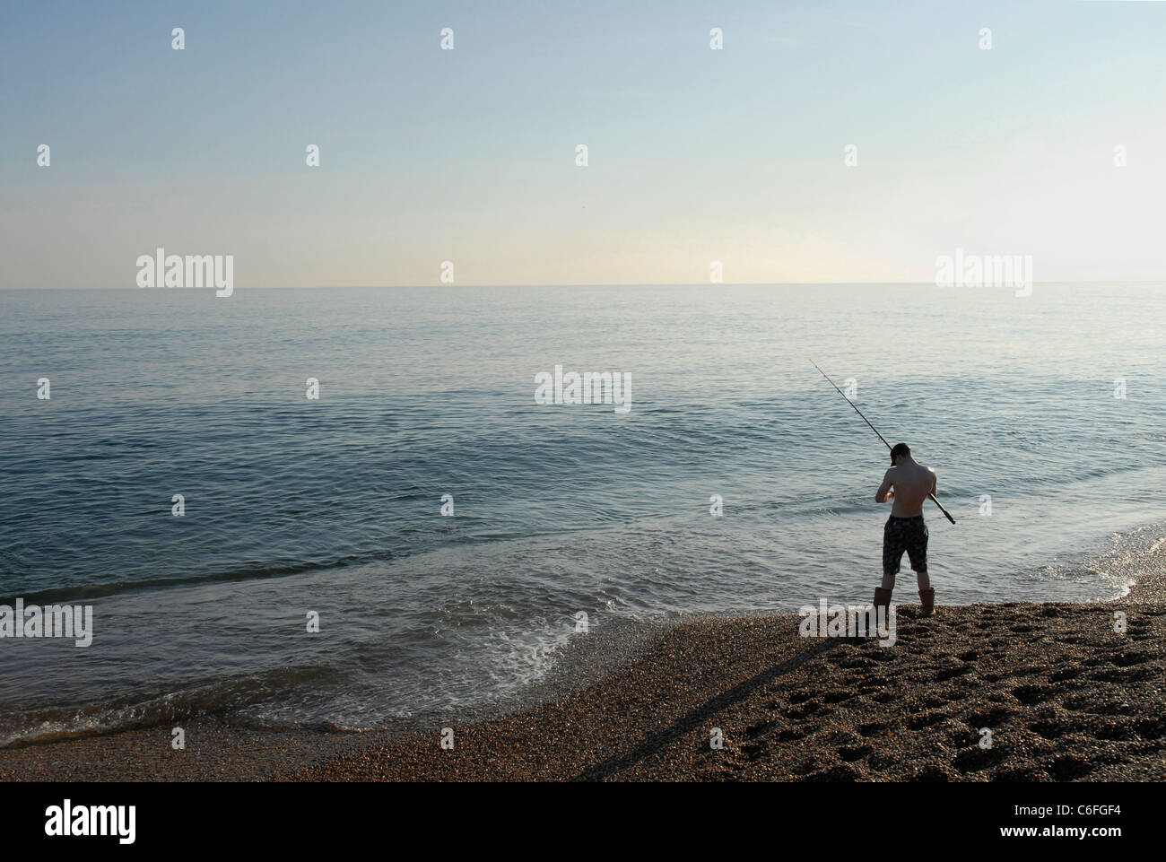 Fishing from Chesil Beach in Dorset Stock Photo Alamy