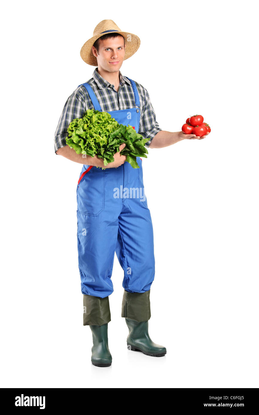 Full length portrait of a male farmer holding vegetables Stock Photo