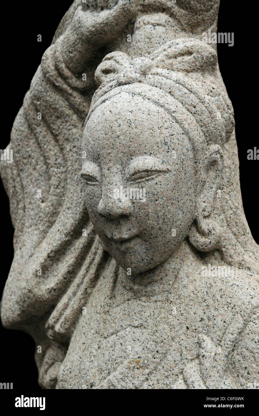 stone carving of an Asian woman from Thai temple with black background Stock Photo
