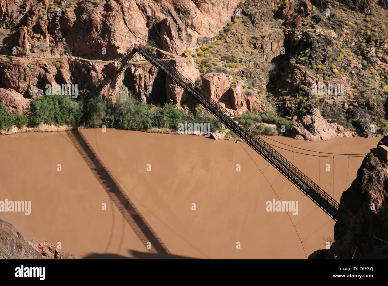 a mule train crossed the black bridge over the Colorado River in the Grand Canyon, Arizona Stock Photo