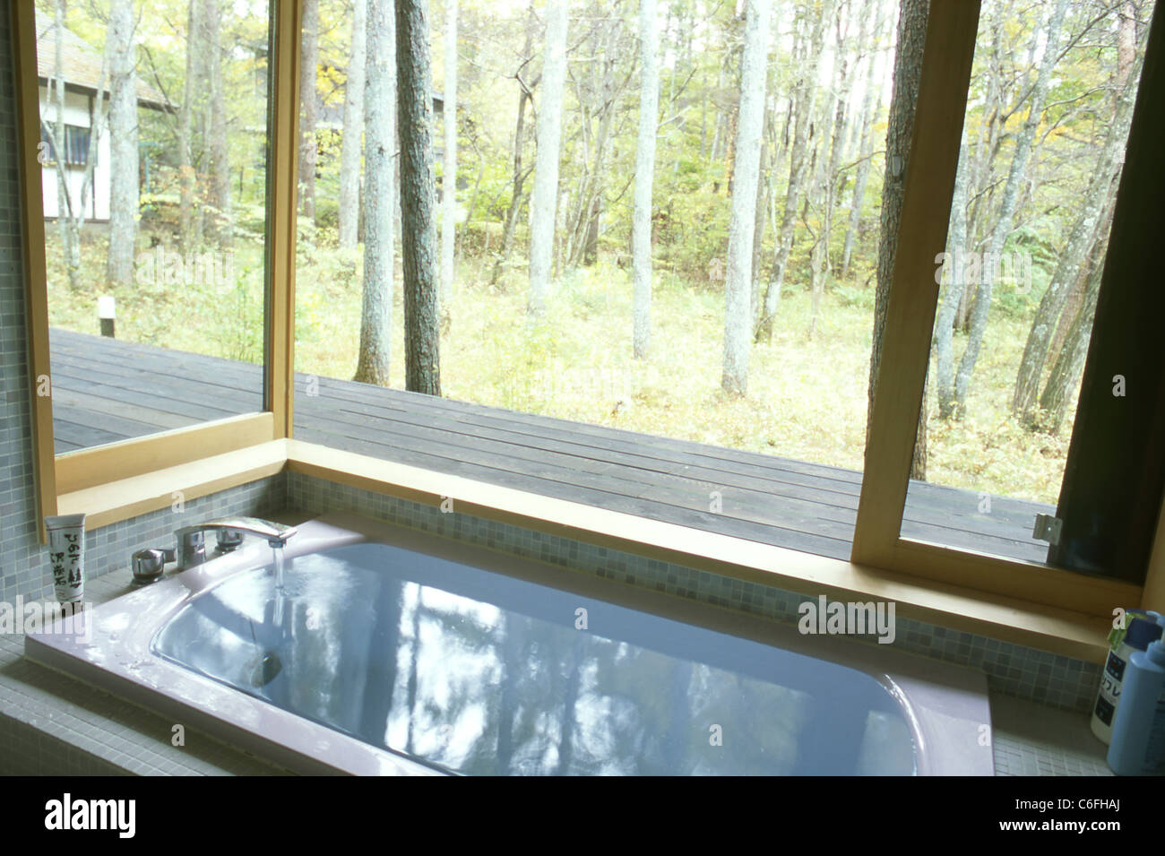 Bath tub in a japanese bathroom with a window toward the wood Stock ...