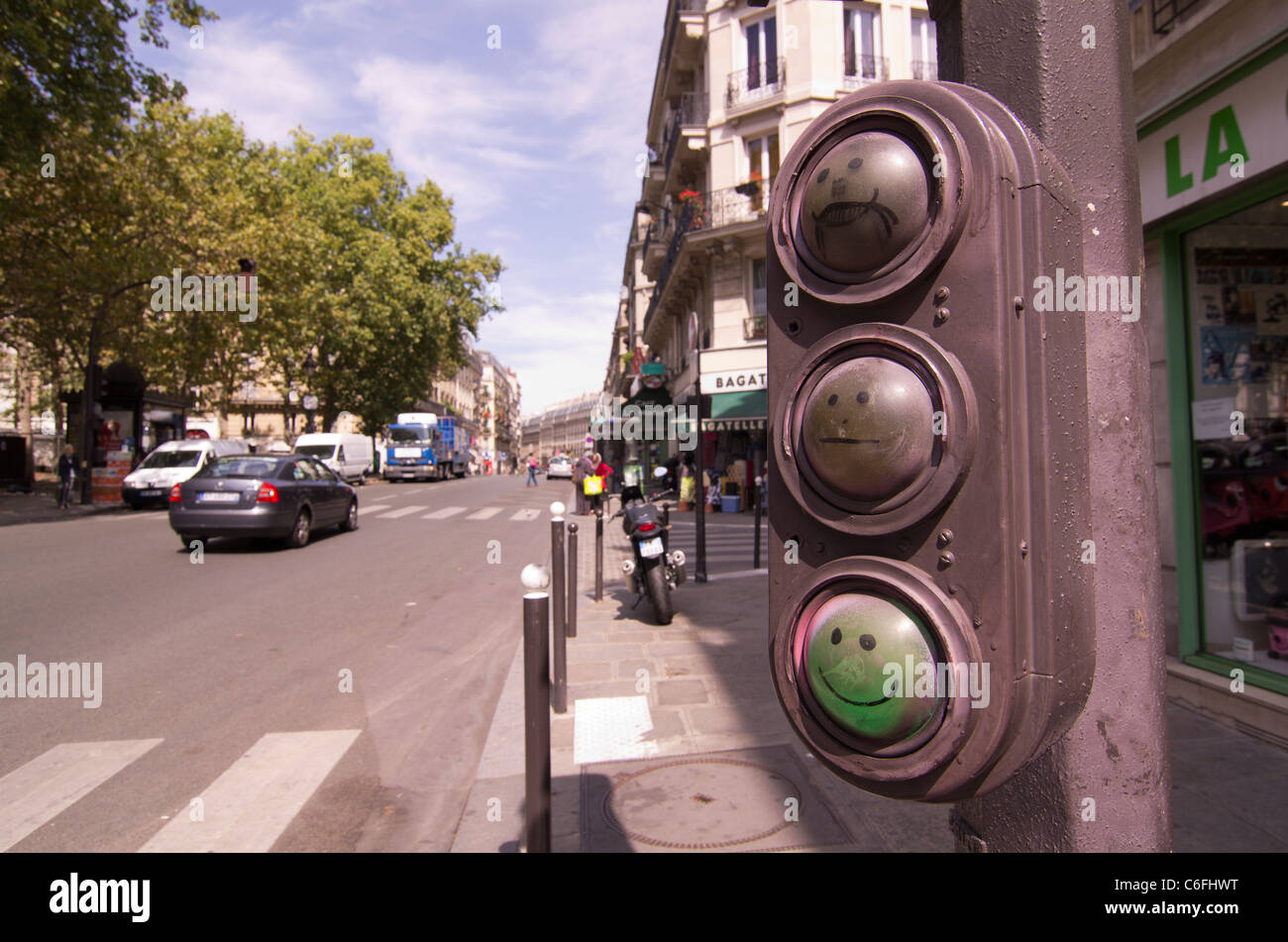 Traffic lights graffitied with faces for amusement onb the Rue Monge in paris, France Stock Photo