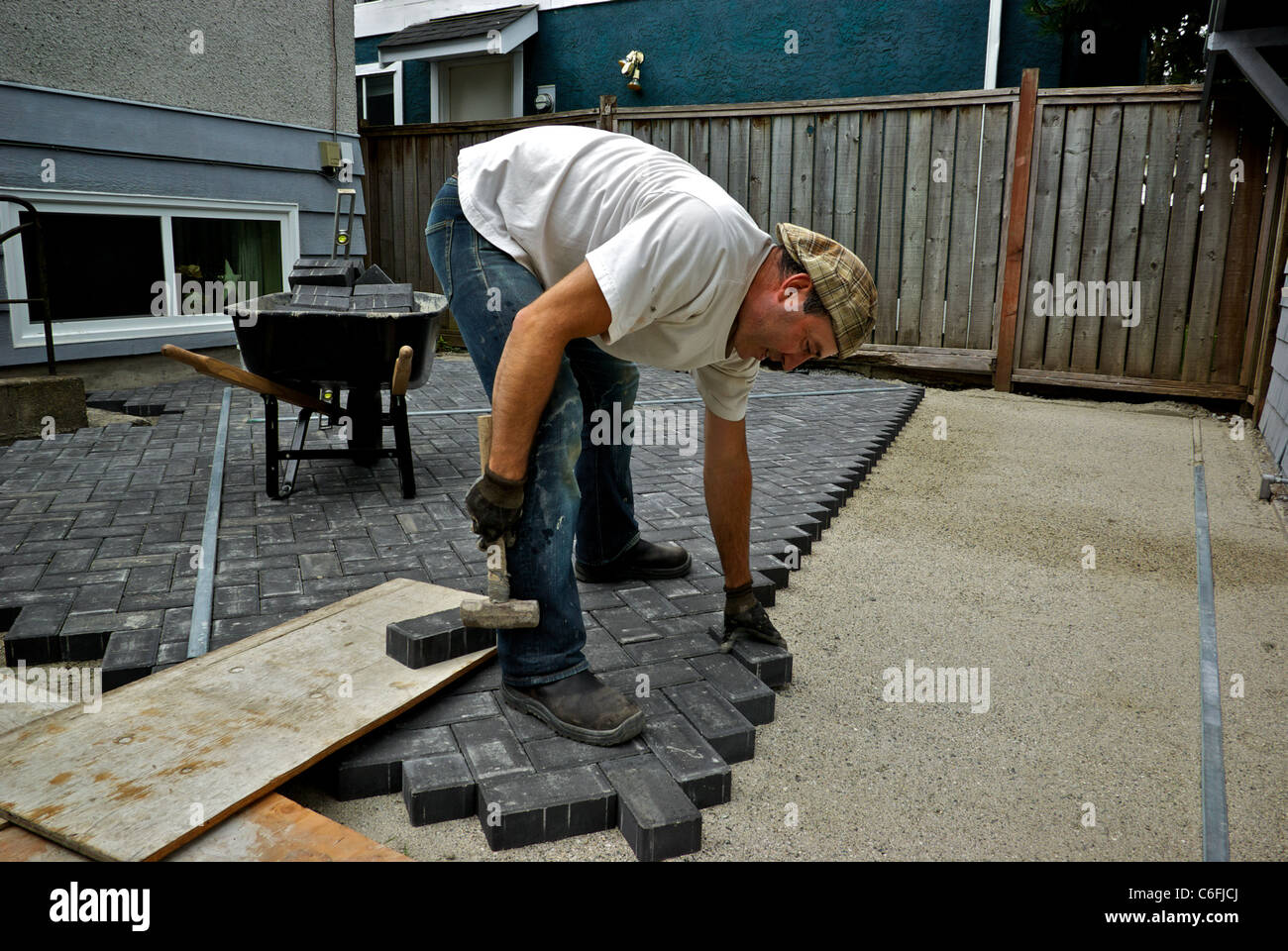 Stonemason Laying Patio Construction Bricks Sand Gravel Base