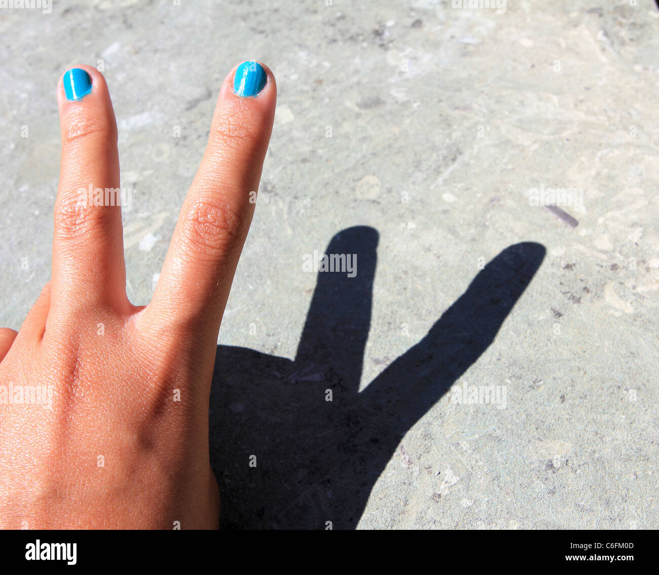 Concept for victory sign made with hand and shadow Stock Photo