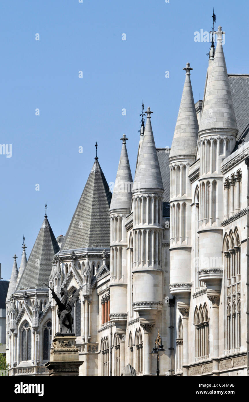 Victorian architecture turrets & windows in stone façade at roof level on part of Royal Courts of Justice building in Strand City of London England UK Stock Photo