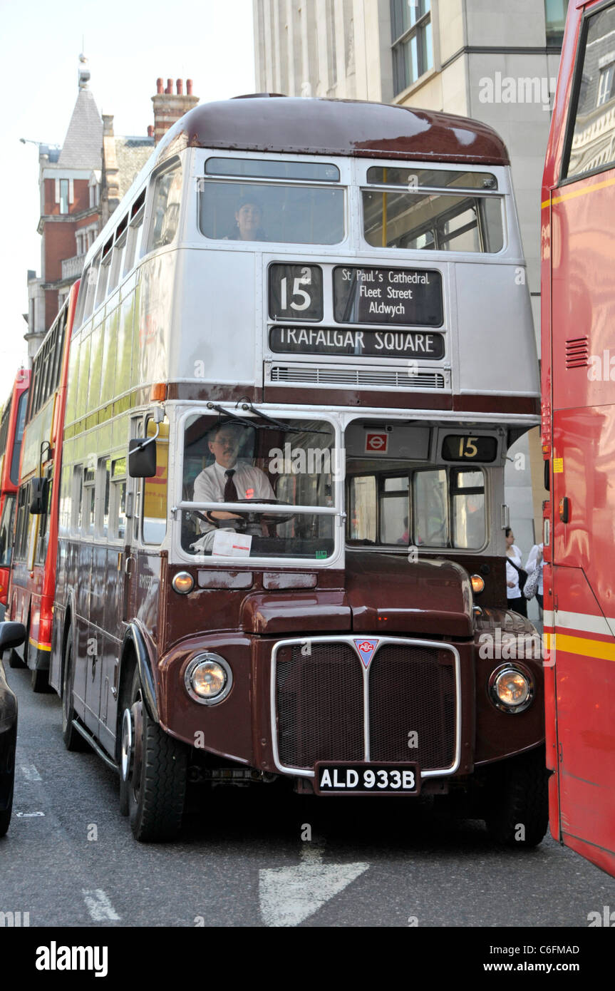 London street scene double decker bus driver & Routemaster RM1933 painted special livery commemorate 75th anniversary of London Transport Strand UK Stock Photo