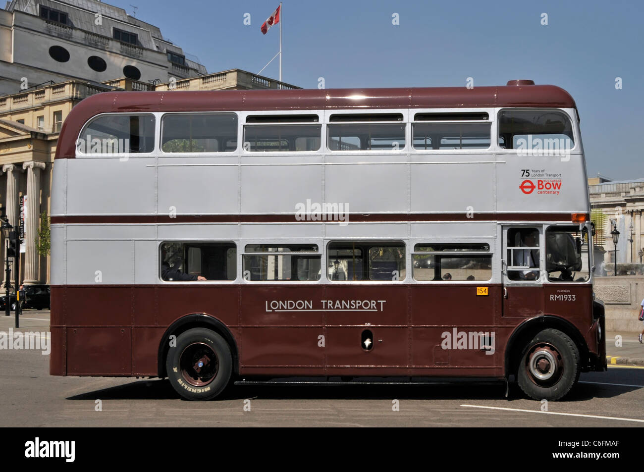 London street scene side double decker Routemaster bus RM1933 special livery commemorate 75th anniversary London Transport Trafalgar Square London UK Stock Photo