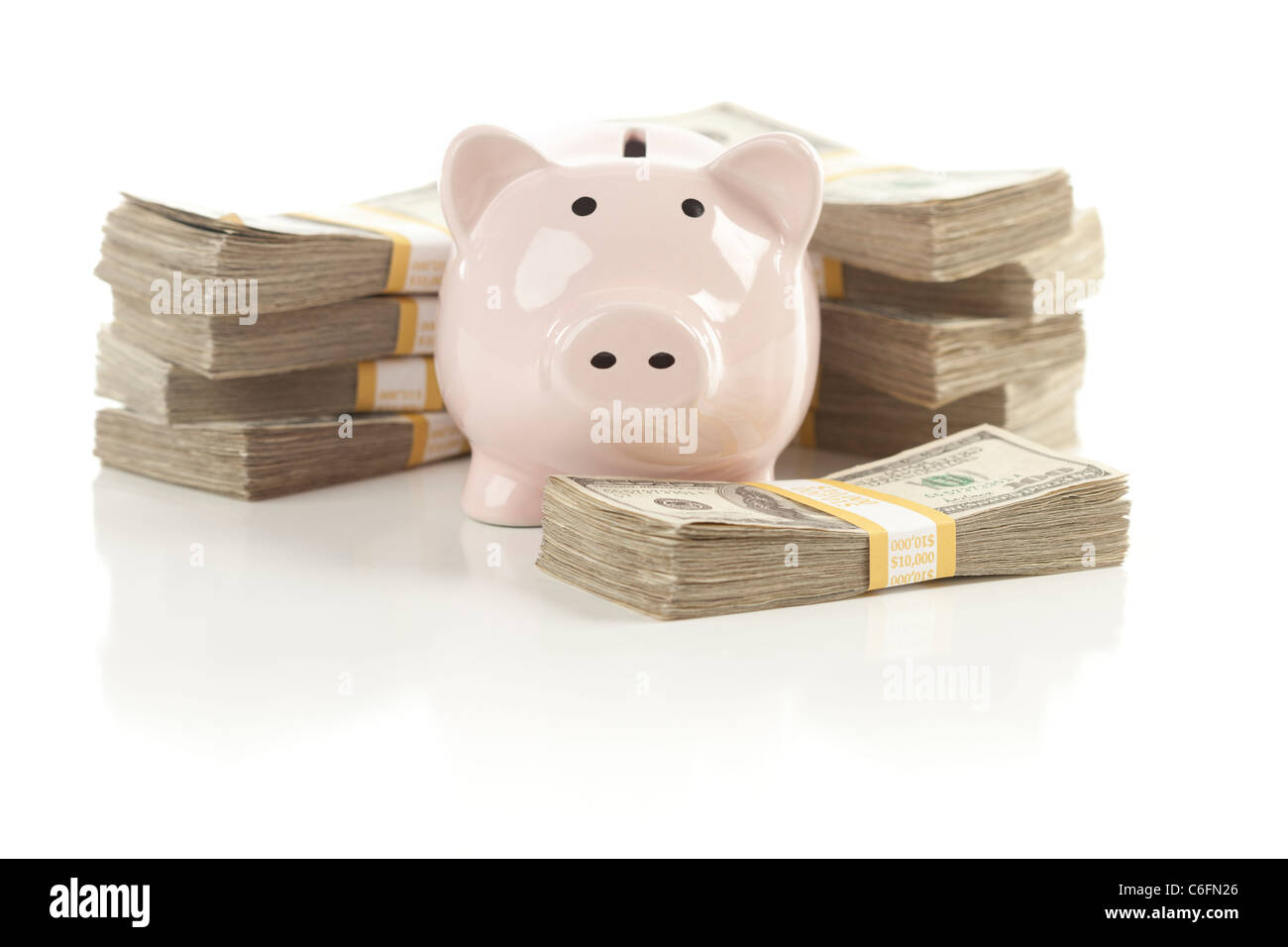 Pink Piggy Bank with Stacks of Hundreds of Dollars Isolated on a White Background. Stock Photo