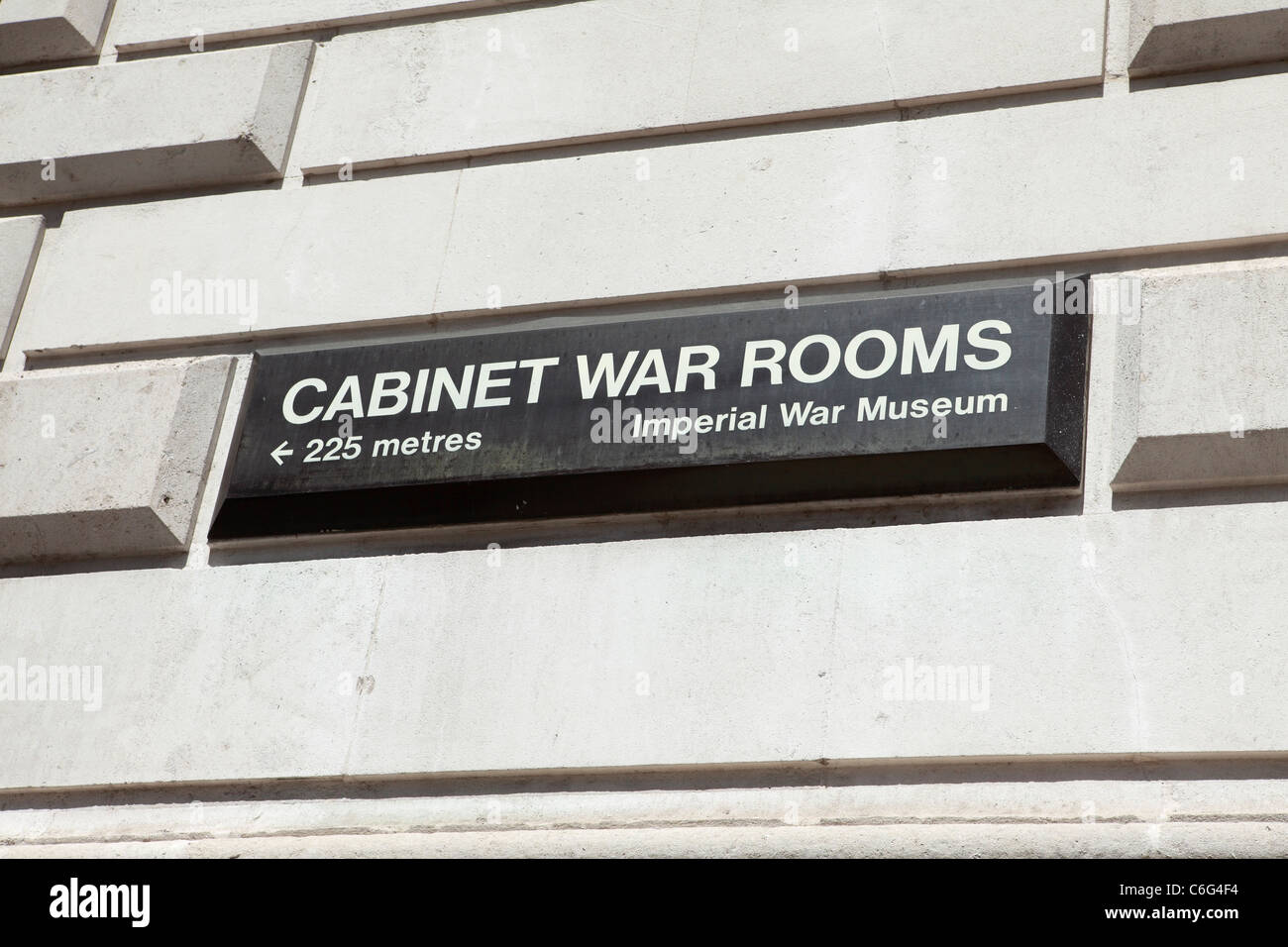 A sign points to the Cabinet War Rooms in Whitehall, London, England, UK. Stock Photo