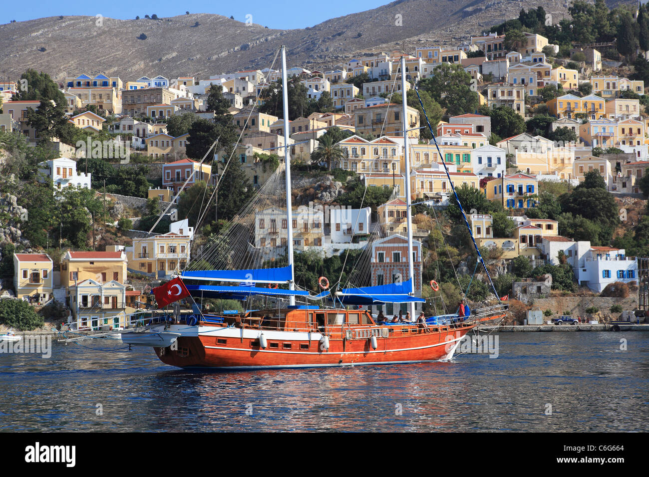 Turkish gulet sailing into Symi harbour in Greece Stock Photo Alamy