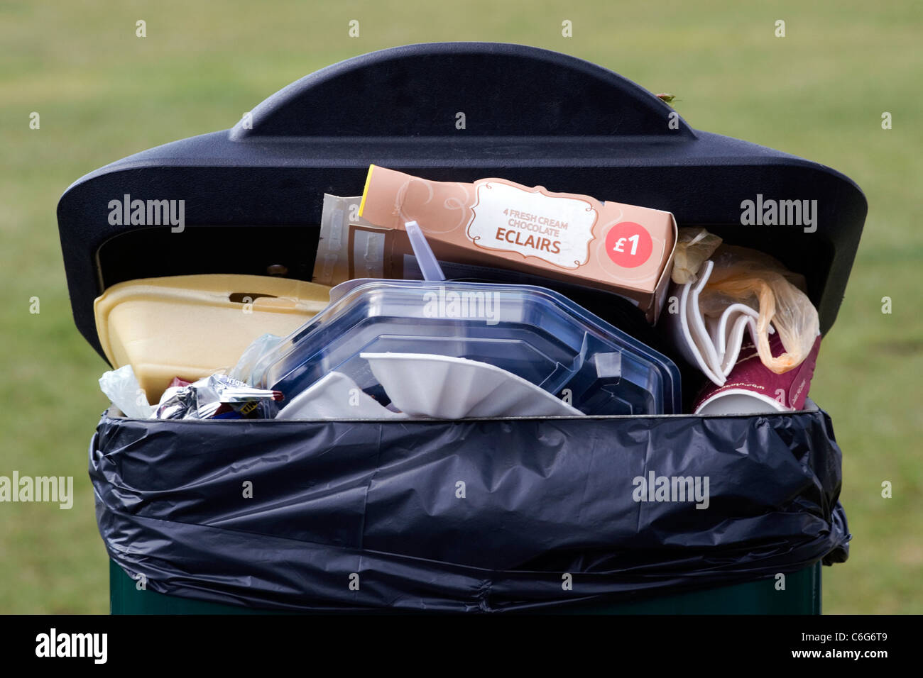 overflowing litter bin at a public event Stock Photo