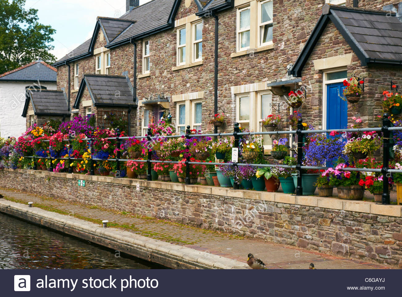 Row Terraced Holiday Cottages With Hanging Baskets And Flower