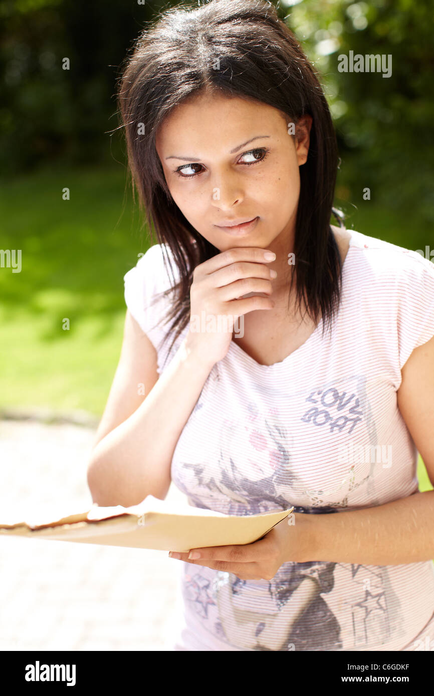 Asian girl looking at exam results Stock Photo