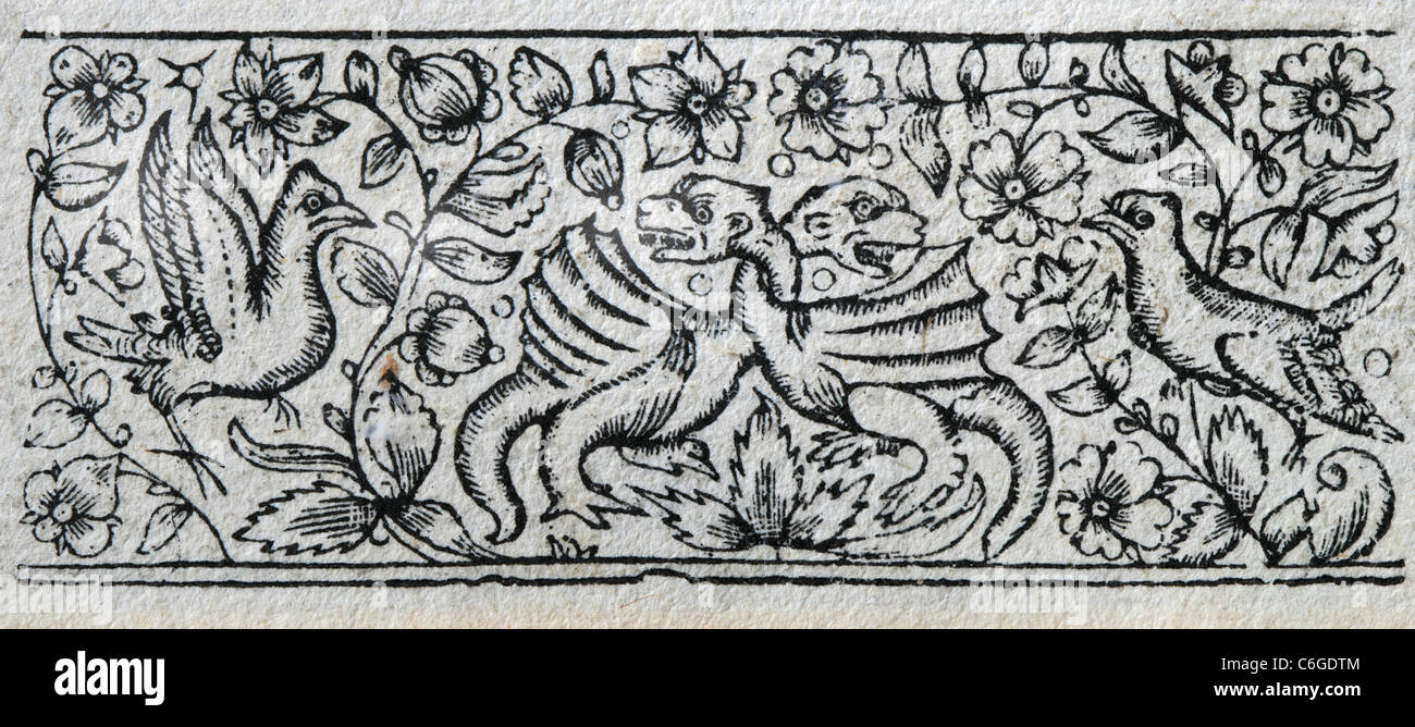 antique wood print from 17th century book of prayer with floral design and birds and dragons Stock Photo