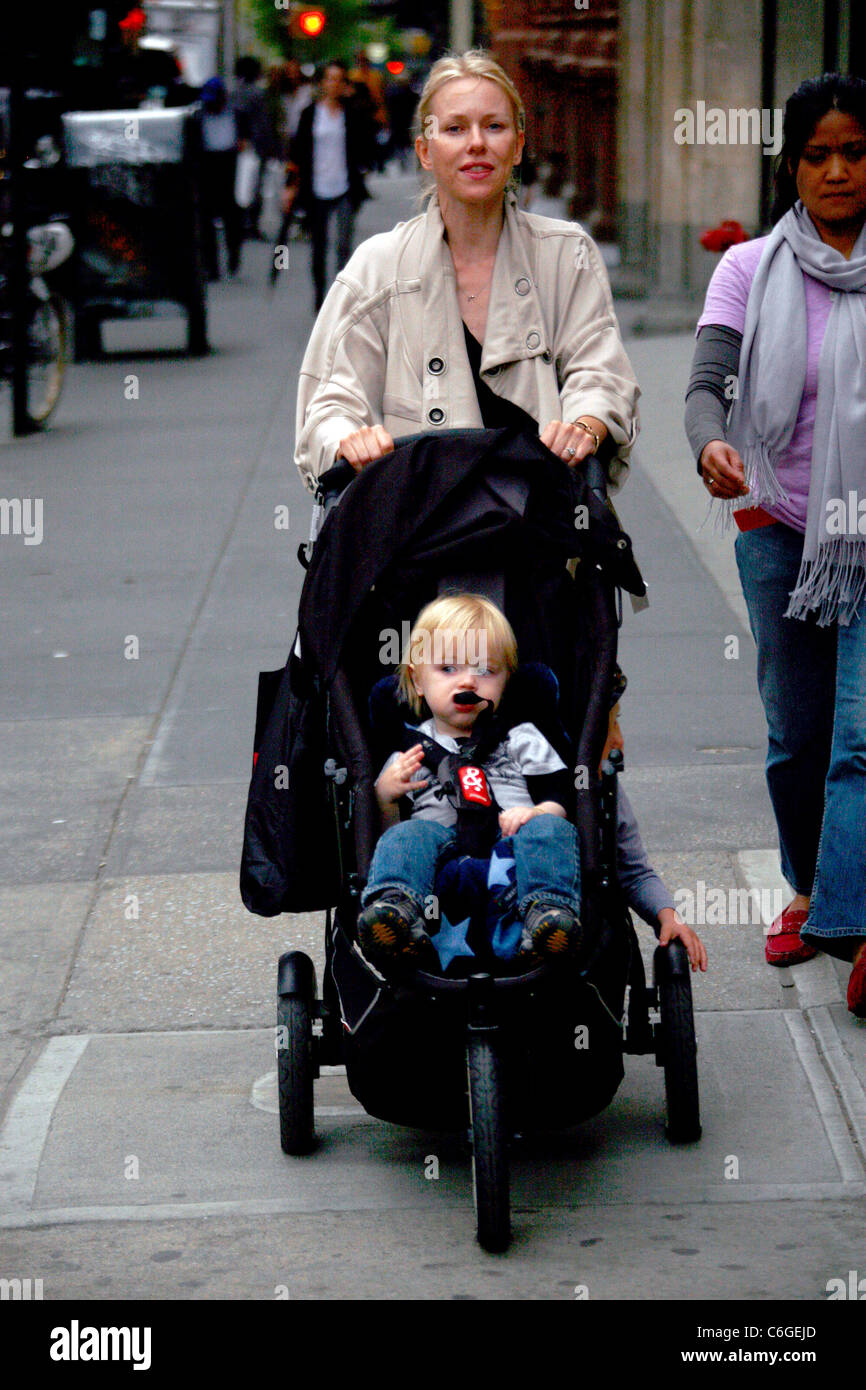 Naomi Watts and Samuel Kai Schreiber Naomi Watts pushing her children in a stroller while walking in Soho with her nanny New Stock Photo