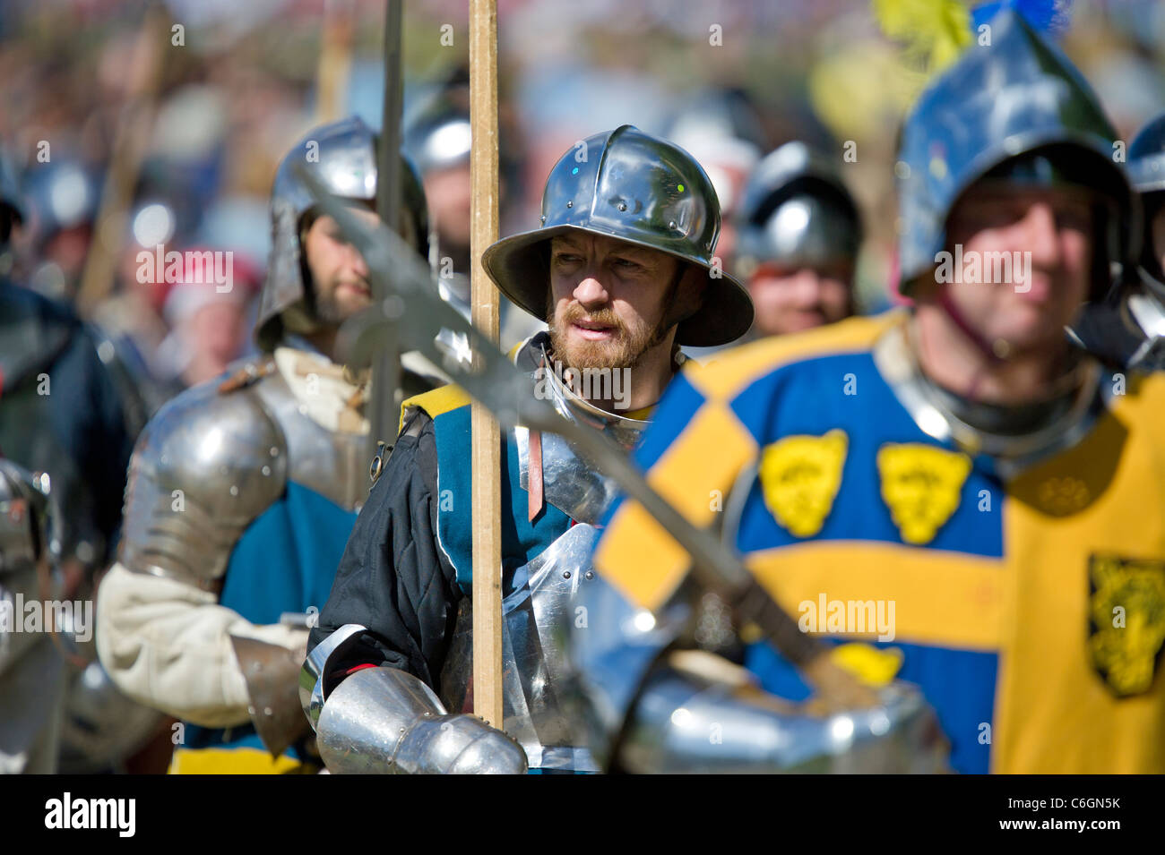 Re-enactors dressed as medieval knights and men-at-arms parade at the Medieval Festival held at Herstmonceux castle in Sussex UK Stock Photo