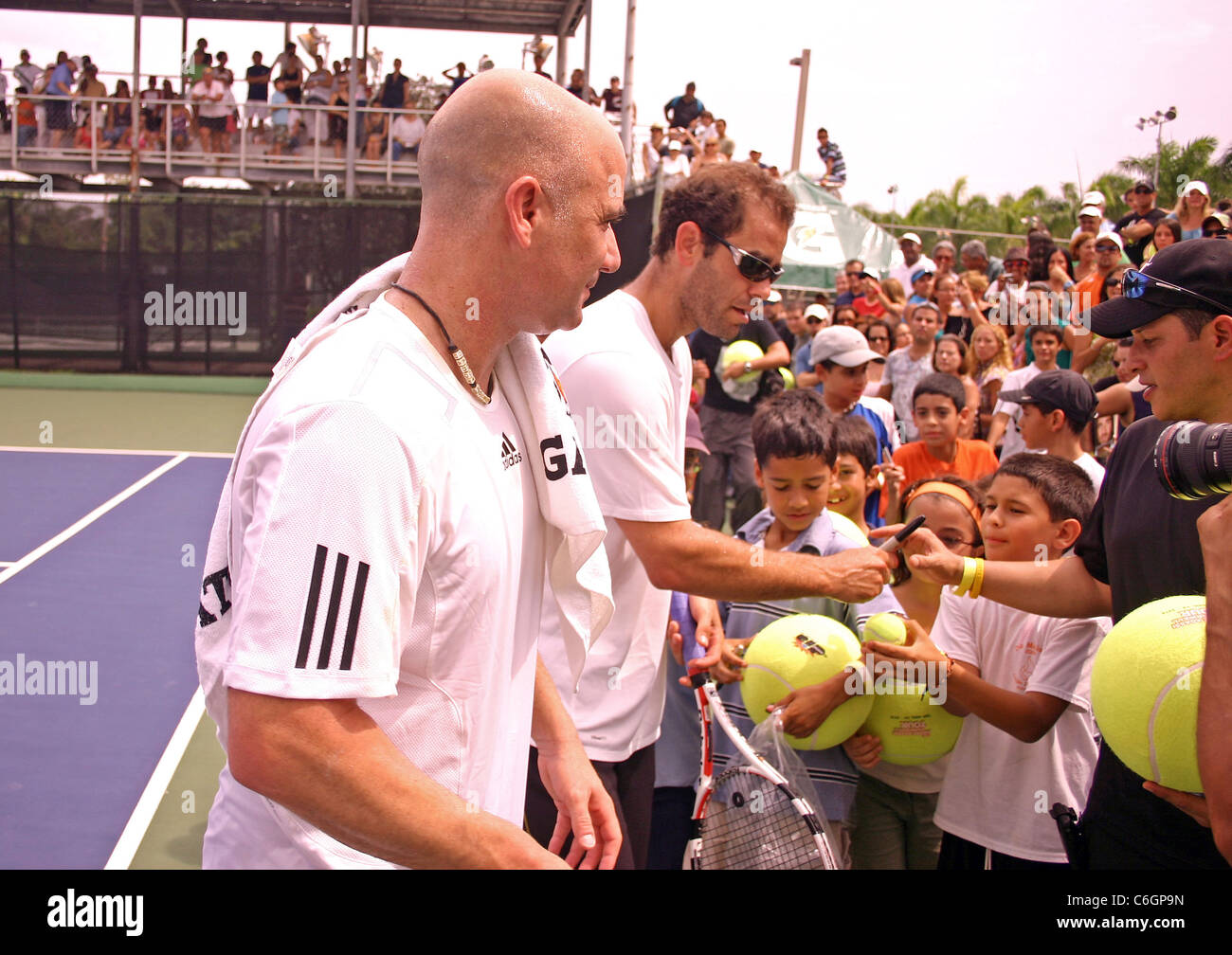 Retired US tennis champions Andre Agassi and Pete Sampras open a free Tennis Clinic to encourage young children to get into the Stock Photo