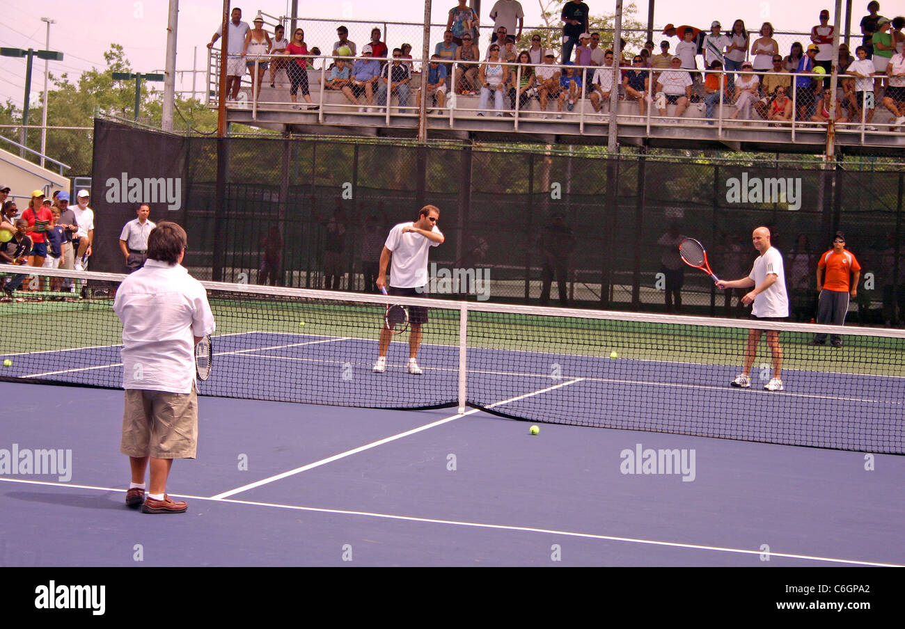 Retired US tennis champions Andre Agassi and Pete Sampras open a free Tennis Clinic to encourage young children to get into the Stock Photo