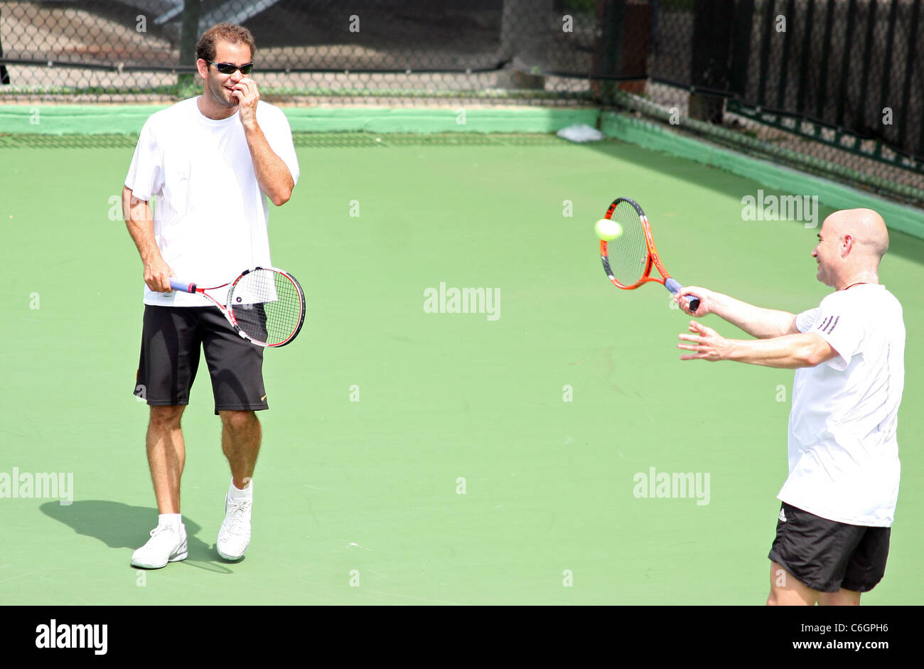 Retired US tennis champions Andre Agassi and Pete Sampras open a free Tennis Clinic to encourage young children to get into the Stock Photo