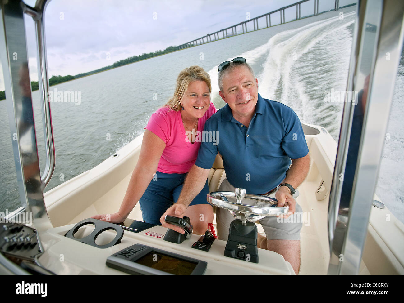 A husband and wife enjoy boating by Daniel Island, South Carolina. Stock Photo