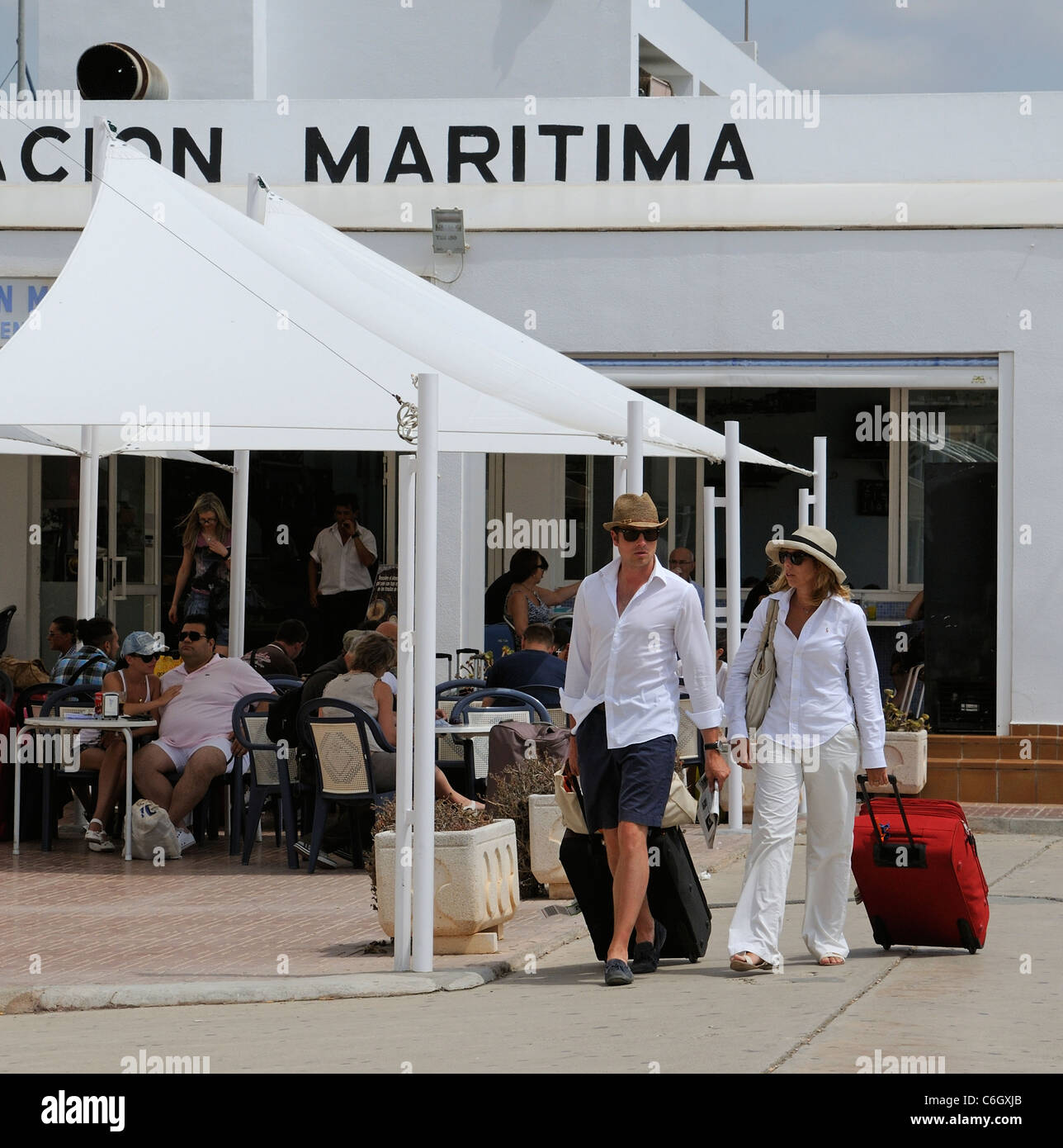 Holidaymakers with luggage on the quayside at Eivissa on the Spanish Island of Ibiza Stock Photo