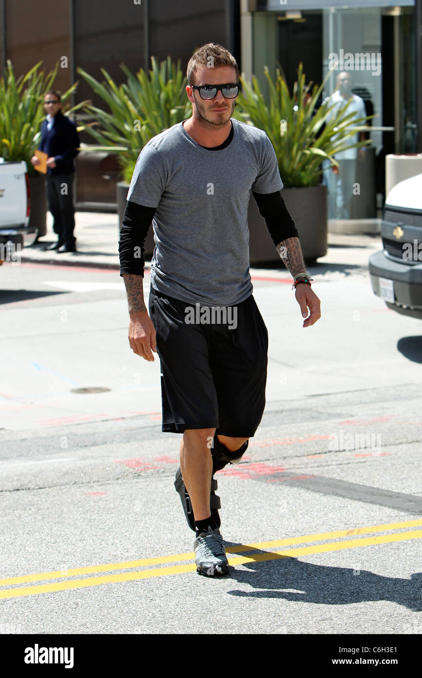 David Beckham layers sporty shorts over compression leggings at