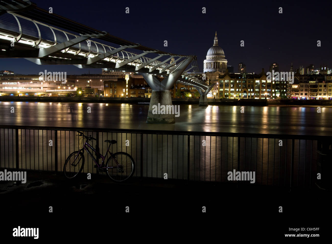 Millennium bridge and St. Paul's cathedral at night. Stock Photo