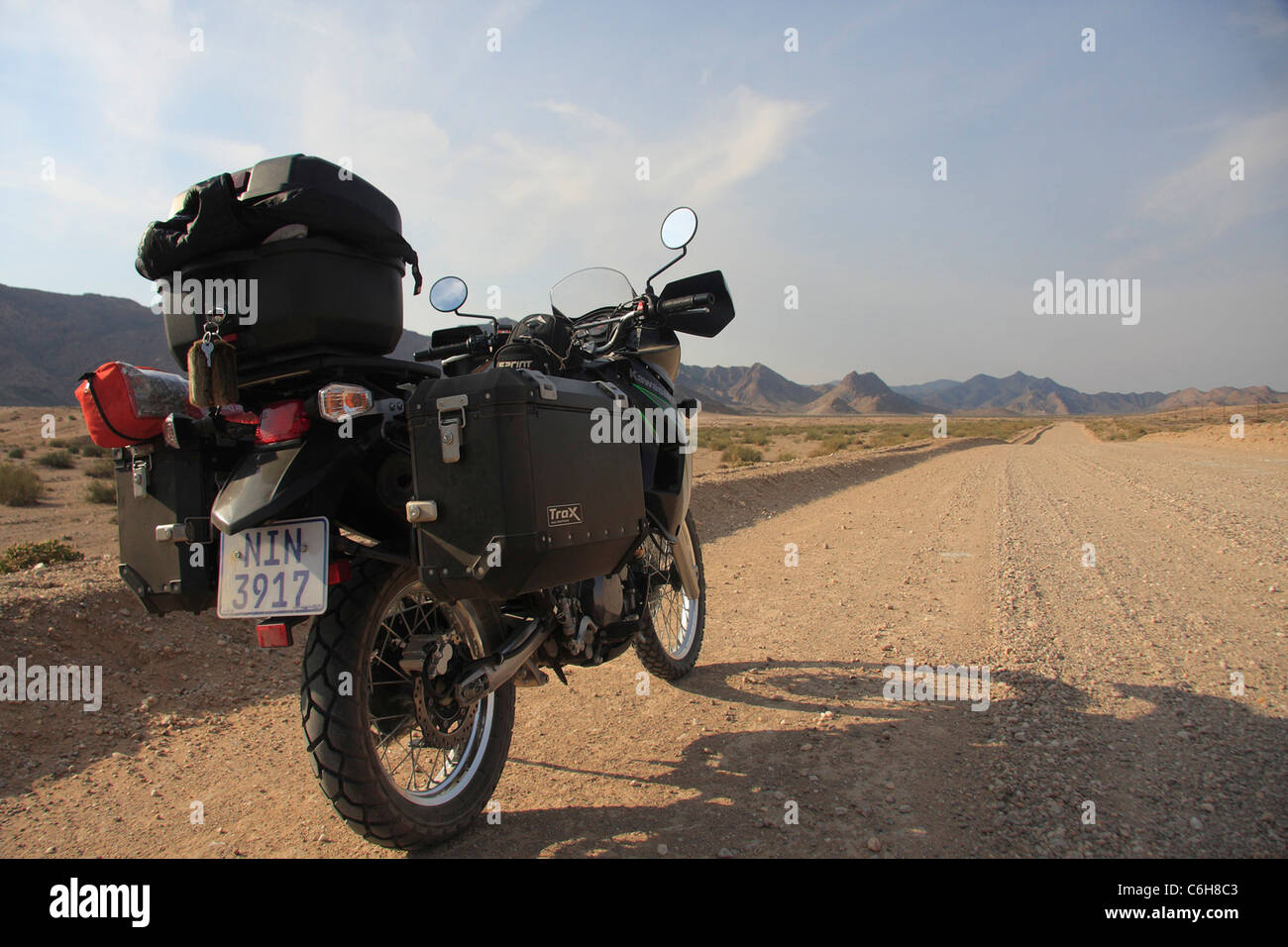 Touring bike on a sand road in arid desert area Stock Photo