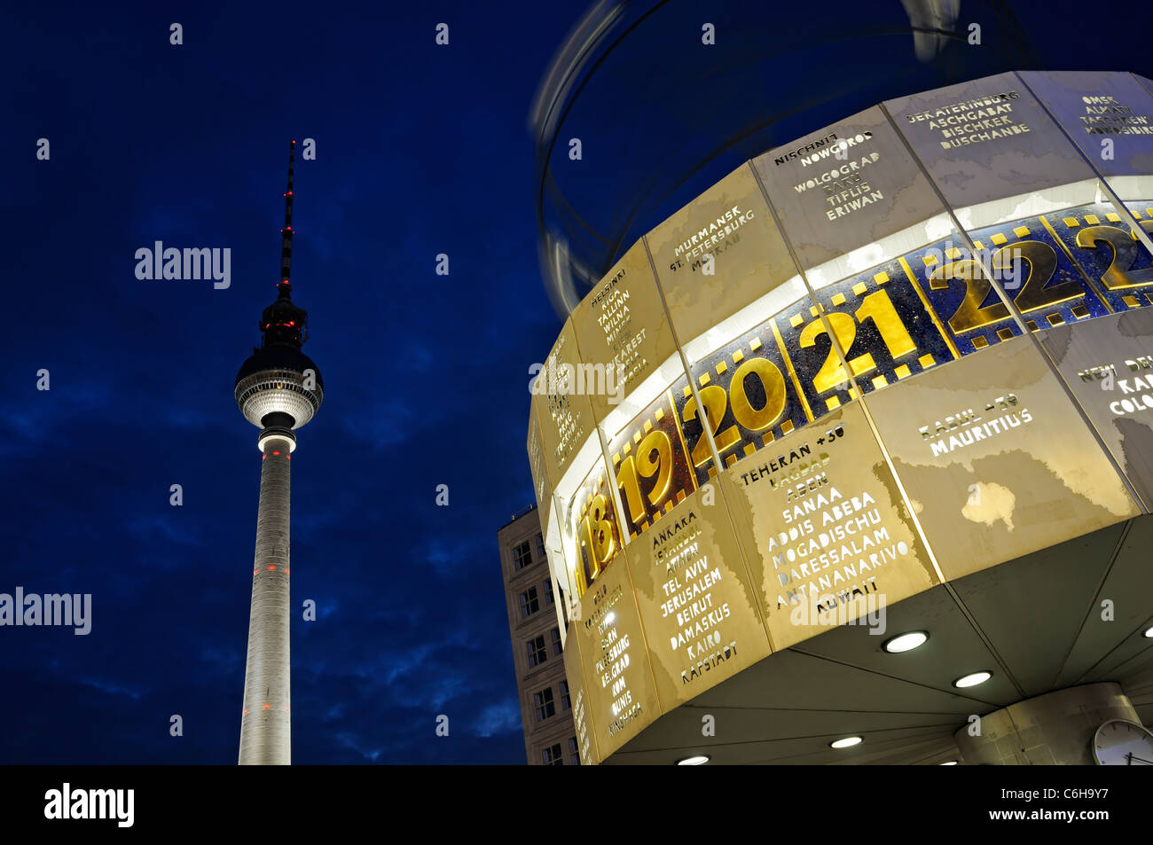 Famous World clock at Alexanderplatz with the TV tower by night, Berlin, Germany. Stock Photo