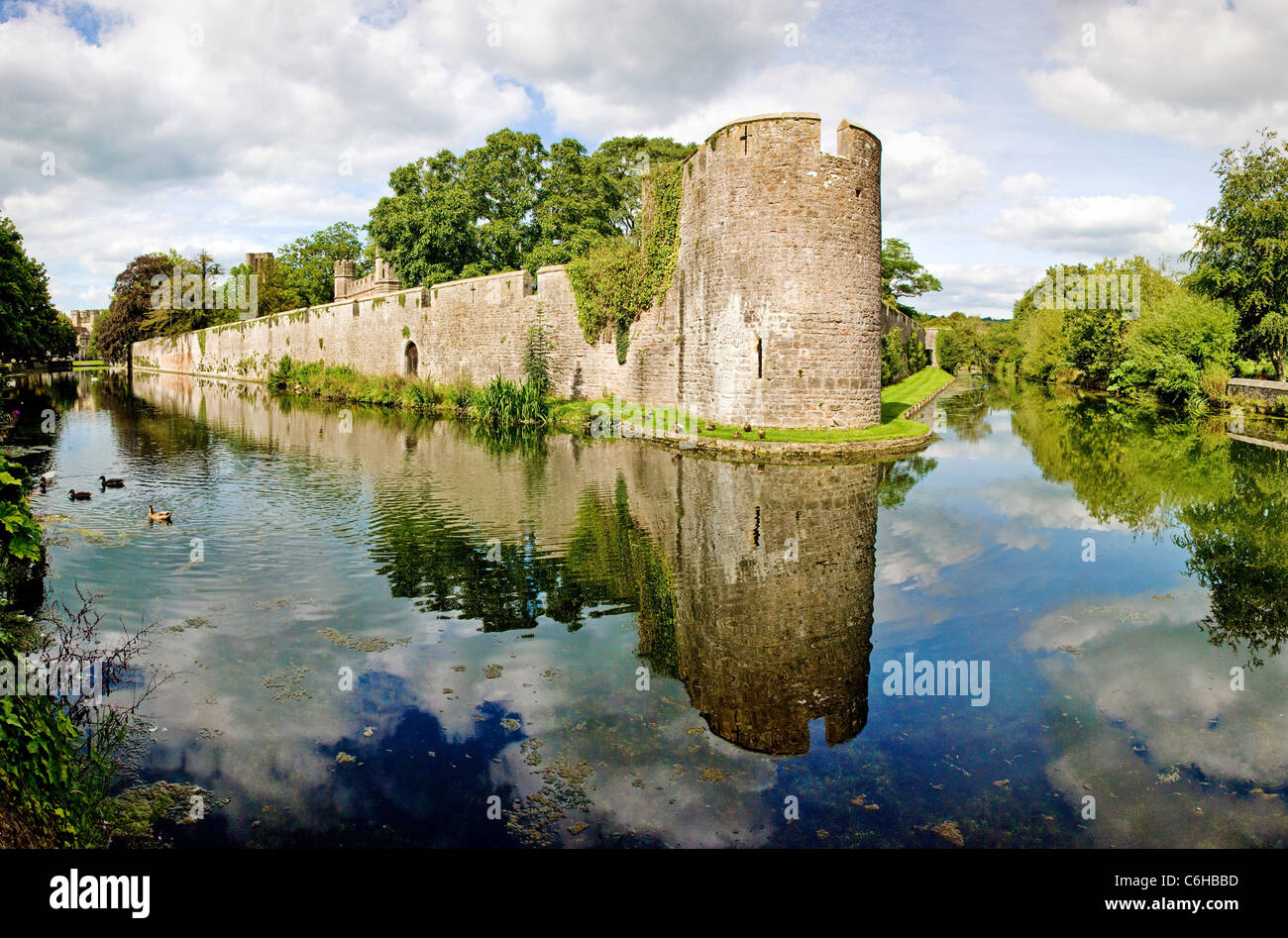 The walls of the Bishop's Palace reflected in the moat at Wells in Somerset Stock Photo