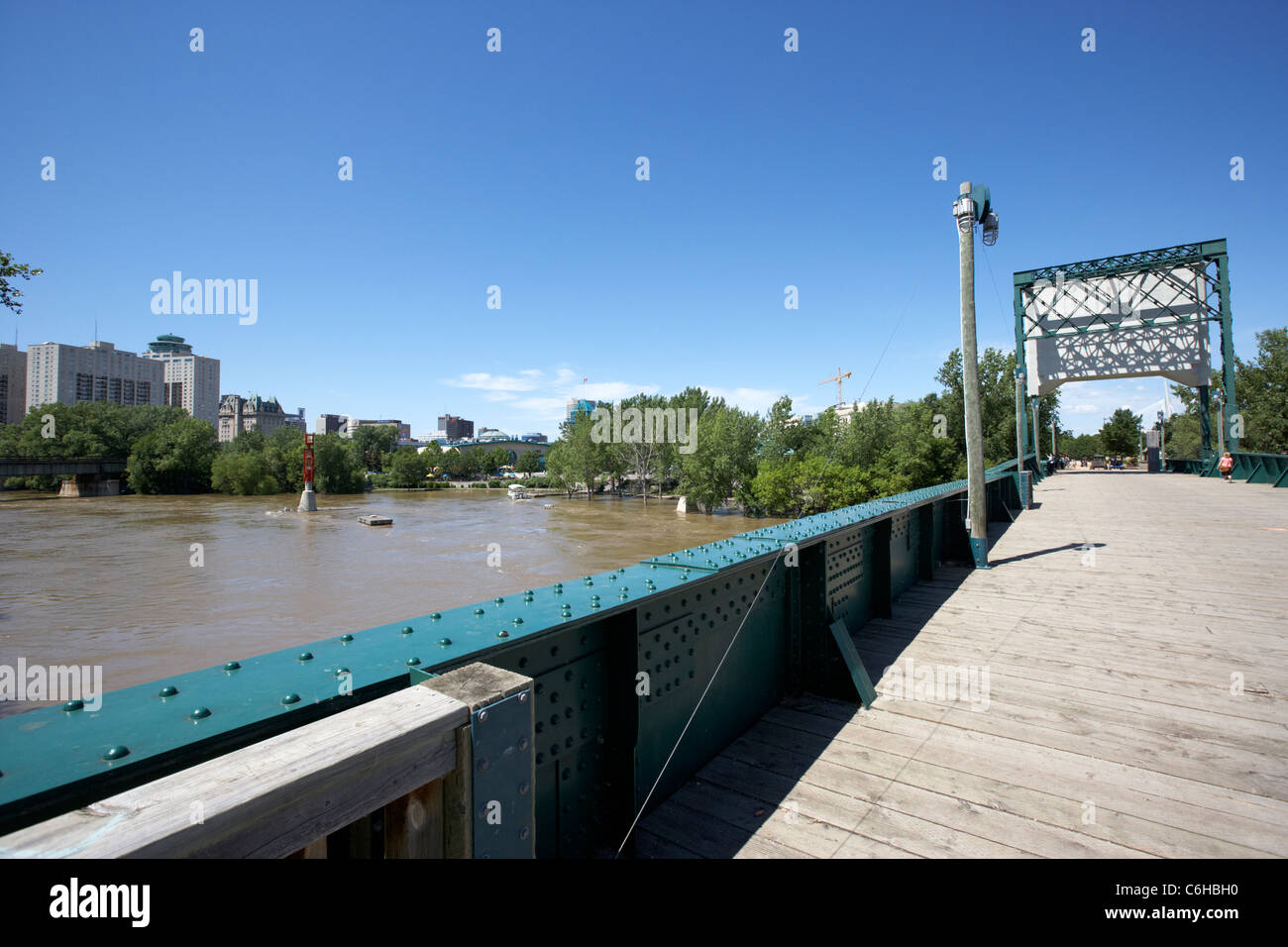 assiniboine river in flood viewed from the old railway bridge in the forks Winnipeg Manitoba Canada Stock Photo
