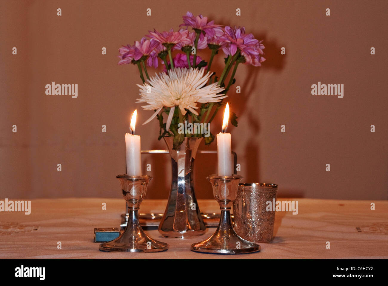 Burning Shabbats Candles and flowers Stock Photo
