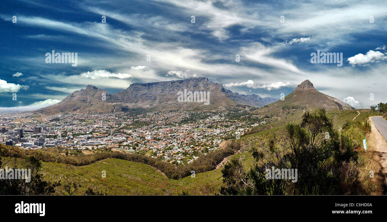 Cape Town nestles below Table Mountain flanked by Signal Hill ( right) and Devils Peak ( left) as seen from Signal Hill. Stock Photo