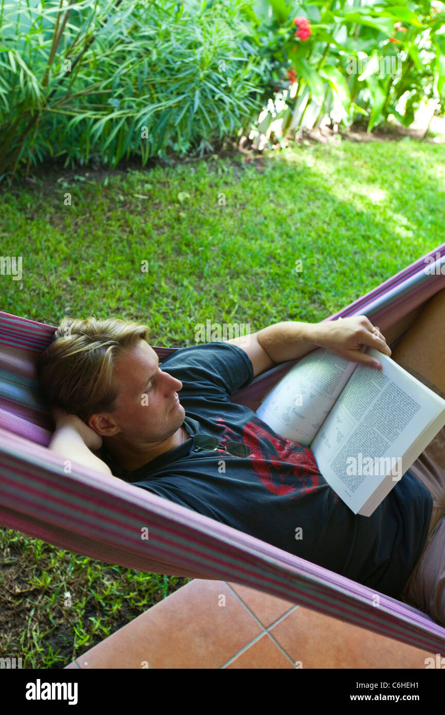 Expat reading a book in a hammock in San Salvador, El Salvador Stock Photo