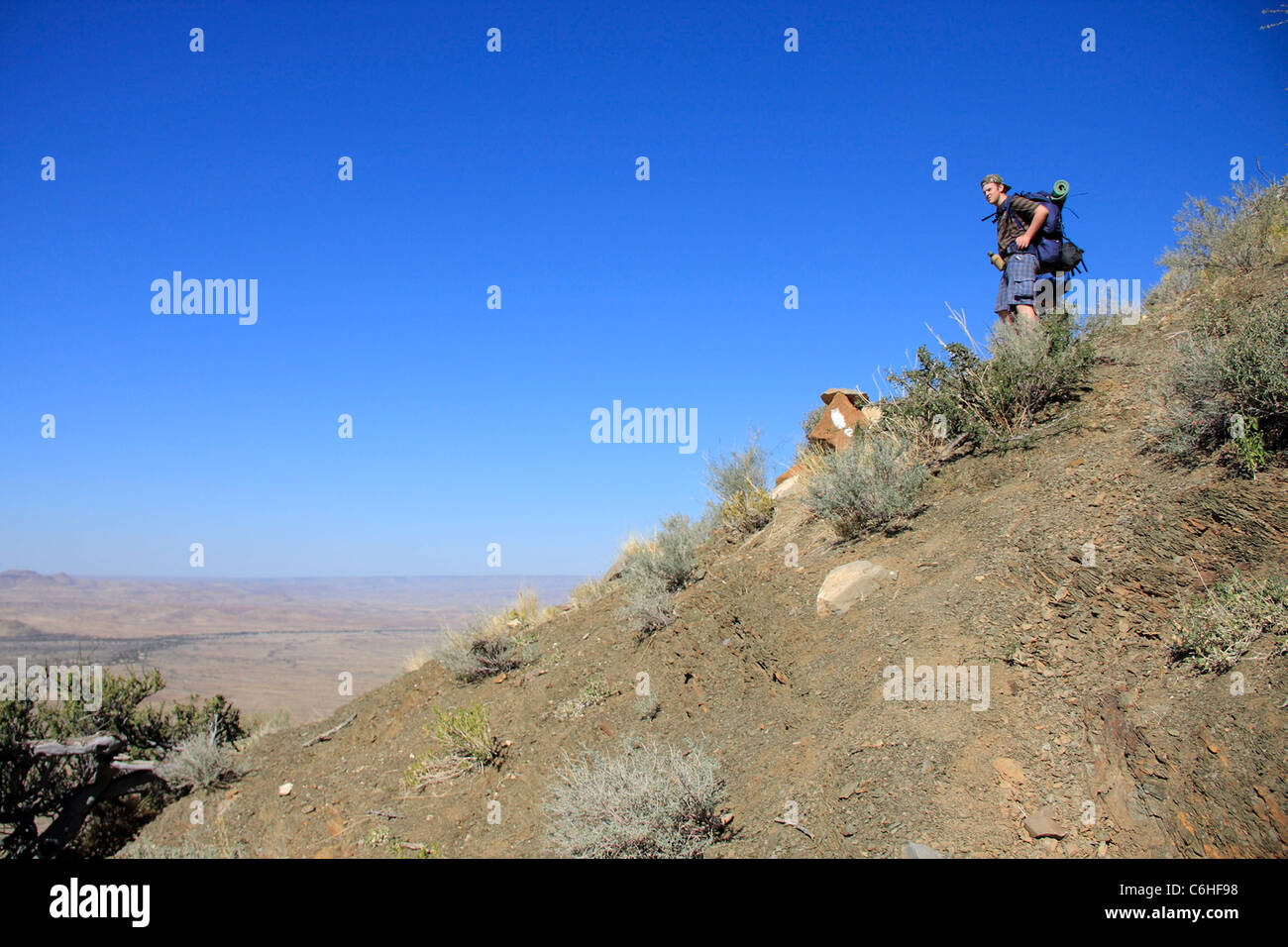 Hiker in desert landscape with footprint marker Stock Photo
