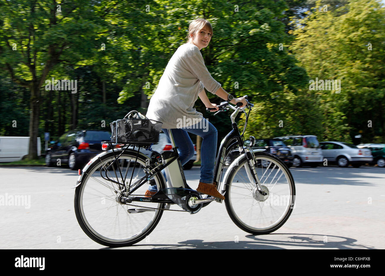 Girl riding on electric bicycle, pedelec, ebike, e-bike, Dortmund, Germany Stock Photo