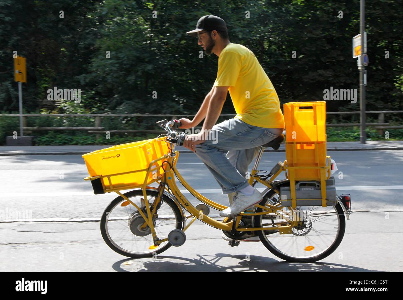 postman riding on electric bicycle, pedelec, ebike, e-bike, Dortmund, Germany Stock Photo