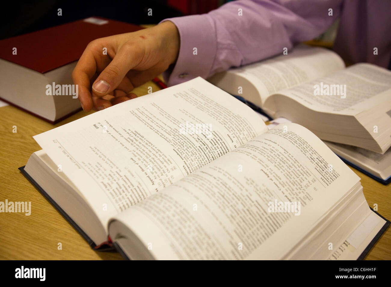 Trainee solicitor studying and researching in a law firm library Stock Photo