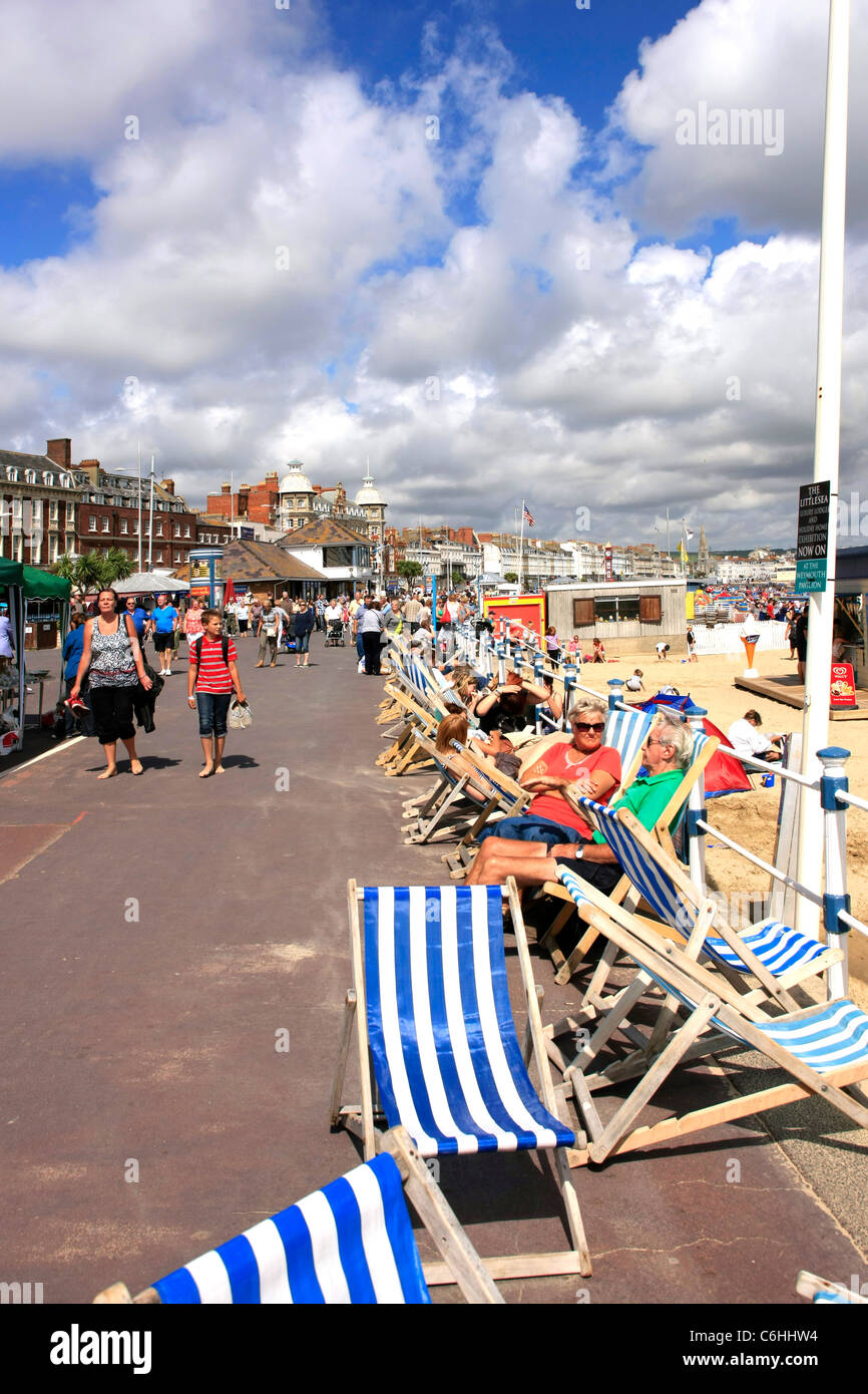 People sitting in deck chairs on Weymouth Seafront Dorset Stock Photo Alamy