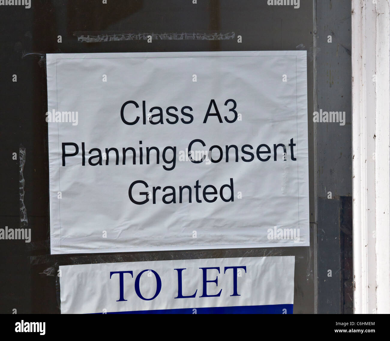 To Let Sign In Window Of Empty Shop To Let In England Town With Class to-let-sign-in-window-of-empty-shop-to-let-in-england-town-with-class