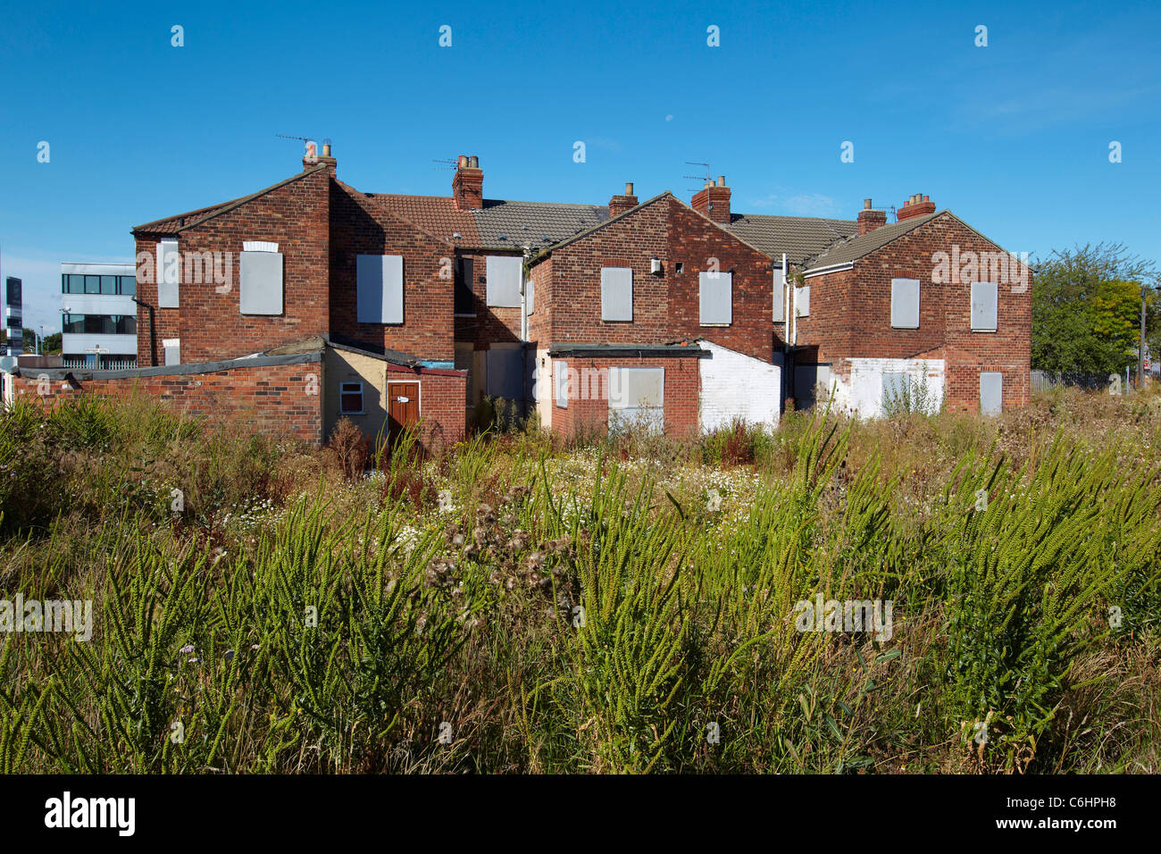 A row of empty abandoned derelict boarded up houses near Woodcock
