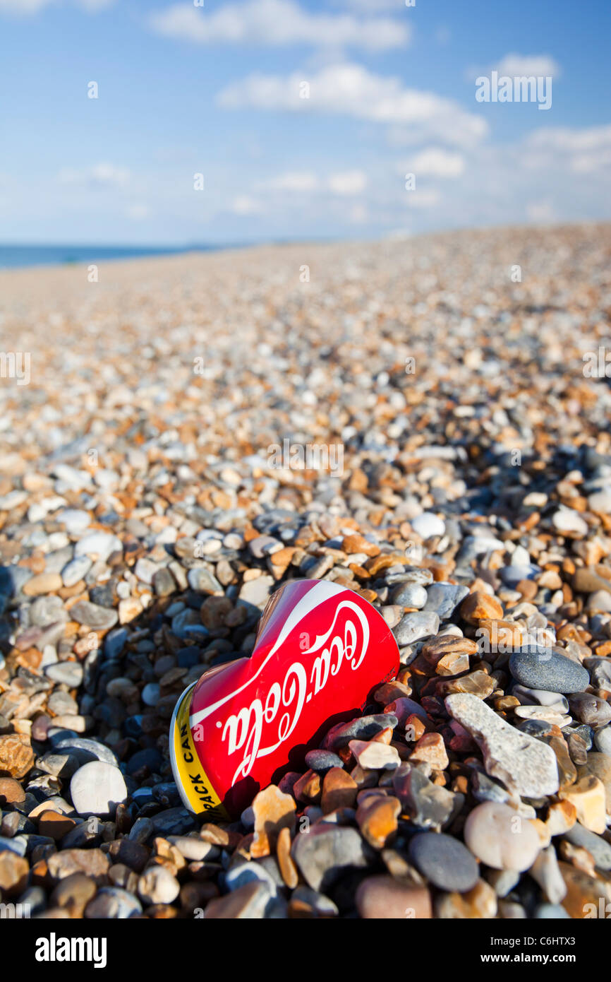 A coke can on the beach at Cley, North Norfolk coast, UK. Stock Photo