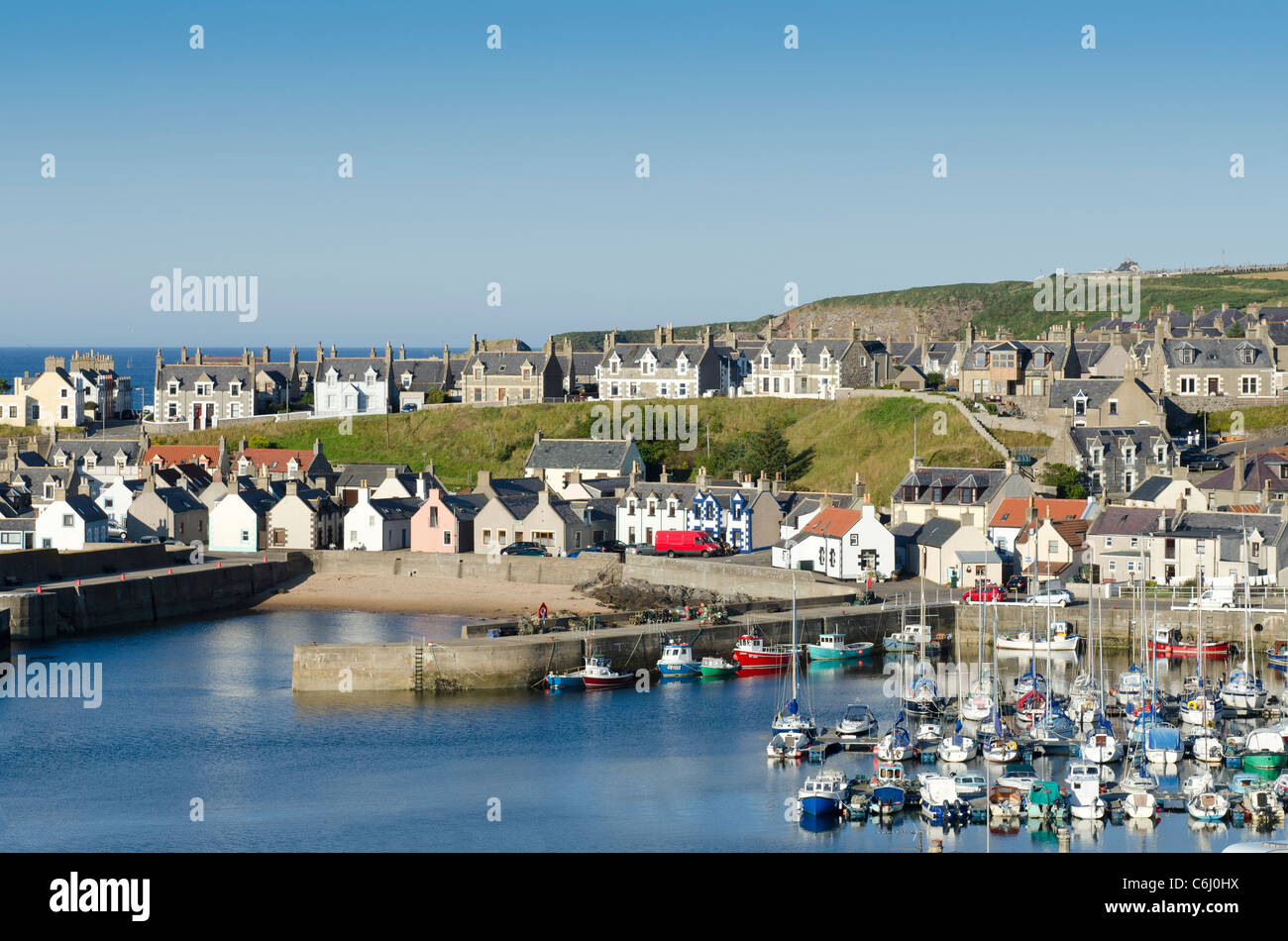 Findochty Harbour with gable ends and sailing vessels on fine day - Moray Coast Stock Photo